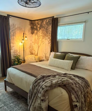 Master bedroom with king bed and forest mural wall